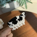 Close-up of cute black and white cow print hair claw clip made of acetate material - Cow