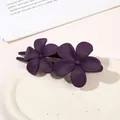 Close-up of matte dark purple double flower hair clip on elegant ceramic tray - Double Flower Clip - Matte Purple