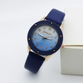 Detail of blue gradient wavy dial with rose gold Arabic numerals on quartz watch - Blue