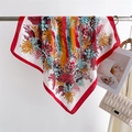 Detail of silk square scarf featuring vibrant floral patterns and red border accent - Red