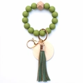 Detail of green silicone beads and leather tassel on a wooden bead keychain ring - Grass Green