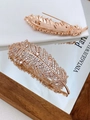 Exquisite rose gold feather brooch with full zircon stones on white silk background - Rose Gold with White Zirconia