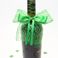 Detail of green lace ribbon bow and shamrock decor on a St. Patrick's Day wine bottle - Lace Bow