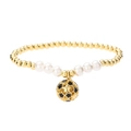 Elegant gold beaded bracelet with white pearls and a hollow star pendant on white backdrop - Black