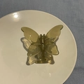 Olive green jelly butterfly hair claw clip with transparent resin finish on white plate - Brown