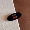 Close-up of a vintage black velvet hair claw clip with a 3D red cherry and green leaf design - Red Cherry Black Velvet Oval Duckbill Clip