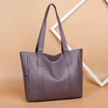 Large soft leather dark purple tote bag for women shown on a beige background - Purple