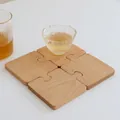 Juego de cuatro posavasos de madera de haya en forma de rompecabezas con acabado natural - Posavasos de Rompecabezas de Haya