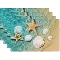 Close-up of four ocean-themed placemats with starfish and shells on sandy beach print - Ocean Sand