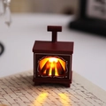 Close-up of a vintage dark red mini fireplace LED lantern on a handwritten script background - Mini Fireplace / Red