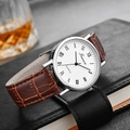 Detailed close-up of a silver men's quartz watch with brown leather strap and white dial - White Dial Brown Strap with Roman Numerals