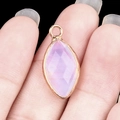 Marquise cut pink-purple stone pendant with golden metal border and top loop ring - Opal (Synthetic)