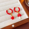 Macro view of gold hoop earrings featuring asymmetrical red apple and mushroom charms - Asymmetric Mushroom & Apple Style / Ear Buckle-Red-Mushroom