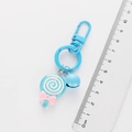 Detail view of a blue lollipop keychain with bell and bow showing exact dimensions - Blue