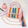 Detail of colorful hand-woven crochet bag with metallic gold lock and fabric fringe charm - Rainbow