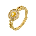 Macro detail of gold evil eye ring with yellow enamel, crystals, and chain link band - Yellow