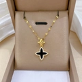 Macro detail of a gold clover pendant with black onyx finish and pavé diamonds - Black Pendant (A308)