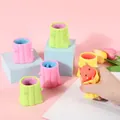 Pink, green, and yellow squirrel tree stump squeeze toys in a cute handheld variant - Tree Stump Squirrel Squeeze Toy