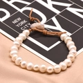 Natural white pearl bracelet with brown cord knot and 18k gold plating details - Full Freshwater Pearl Leather Cord Bracelet