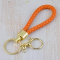 Handmade orange braided leather keychain with golden metal ring on wood background - Generation 1 Round Dragon Woven Buckle (Light Gold) / Orange