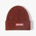 Knit beanie hat in rust red with white NEWYORK logo patch on ribbed turnover cuff - Adjustable / Rust red
