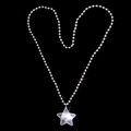 Star pendant necklace with leopard print detail arranged in heart shape on black backdrop - White