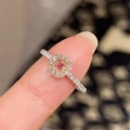 Macro shot of a pink gemstone ring with halo diamonds and a crystal-encrusted band - Large Square Pink Zirconia