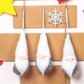Close-up of three knitted Christmas gnomes with grey plush bodies and white pointed hats - Three-Piece Set / White Style (B4-2)