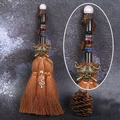 Detail of crystal ball topper and skull badge on a 24cm decorative witch broom pendant - Rose Quartz