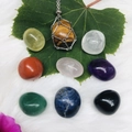 Tiger eye stone necklace with crystal set displayed on green leaves and white fur - Silver Cage with 9Pcs Natural Crystals