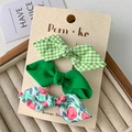 Set of three fabric bow hair clips featuring green plaid, solid green, and floral patterns - Green System
