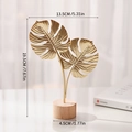 Golden iron monstera leaf ornament with a circular wooden base for home decor - Double Monstera Leaf-Gold