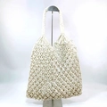 Close-up of white macrame tote bag featuring intricate hollow diamond mesh weave - White