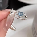 Adjustable silver star ring with a light blue gemstone and minimalist design - Blue Star Ring