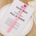 Pink gel pen with cute cartoon pig character topping on a white magazine background - Pink Piggy Bear