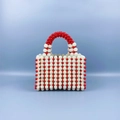 Detailed view of handmade beaded handbag with white pearls and red accent beads - Red