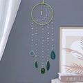 Green dream catcher with natural agate slices and crystal stone on a grey wall - Green Half Moon Agate