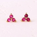 Minimalist gold earrings featuring three round red zircons in a cluster stud design - Rose Red