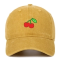 Close-up of cherry embroidery on mustard yellow washed cotton baseball cap texture - Yellow