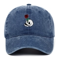 Détail de la broderie crâne et rose sur une casquette de baseball en denim bleu délavé - Bleu marine