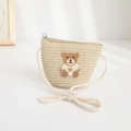 Close-up of children's straw crossbody bag with cute brown teddy bear embroidery detail - 48-52cm / Woven Crossbody Bag / Beige
