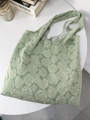 Close-up of light green tote bag featuring intricate rose floral embossed fabric texture - Green Rose Texture