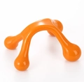 Close-up of an ergonomic orange four-leg manual massager tool for pressure point relief - Orange