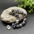 Close-up of moon shaped hair clip with natural blue and white crystals in detail - Blue Sodalite