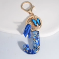 Blue resin letter J keychain with gold flakes, dark blue tassel and butterfly charm - Letter J