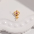 Macro view of a gold-plated heart-shaped pendant bail with a purple gemstone and needle pin - Style D / Gold