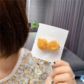 Close-up of a creative fried chicken hair clip with realistic golden crispy texture - Popcorn Chicken