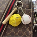 Detailed close-up of a mini baseball keychain with wooden bat and leather glove on a bag - 3.5CM White Ball Yellow