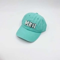 Top view of a mint green cotton baseball cap featuring embroidered MINI letter patch - Kids MINI / Cyan