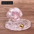 Cat paw resin ornament with kunzite crystal chips and a round decorative base - Kunzite